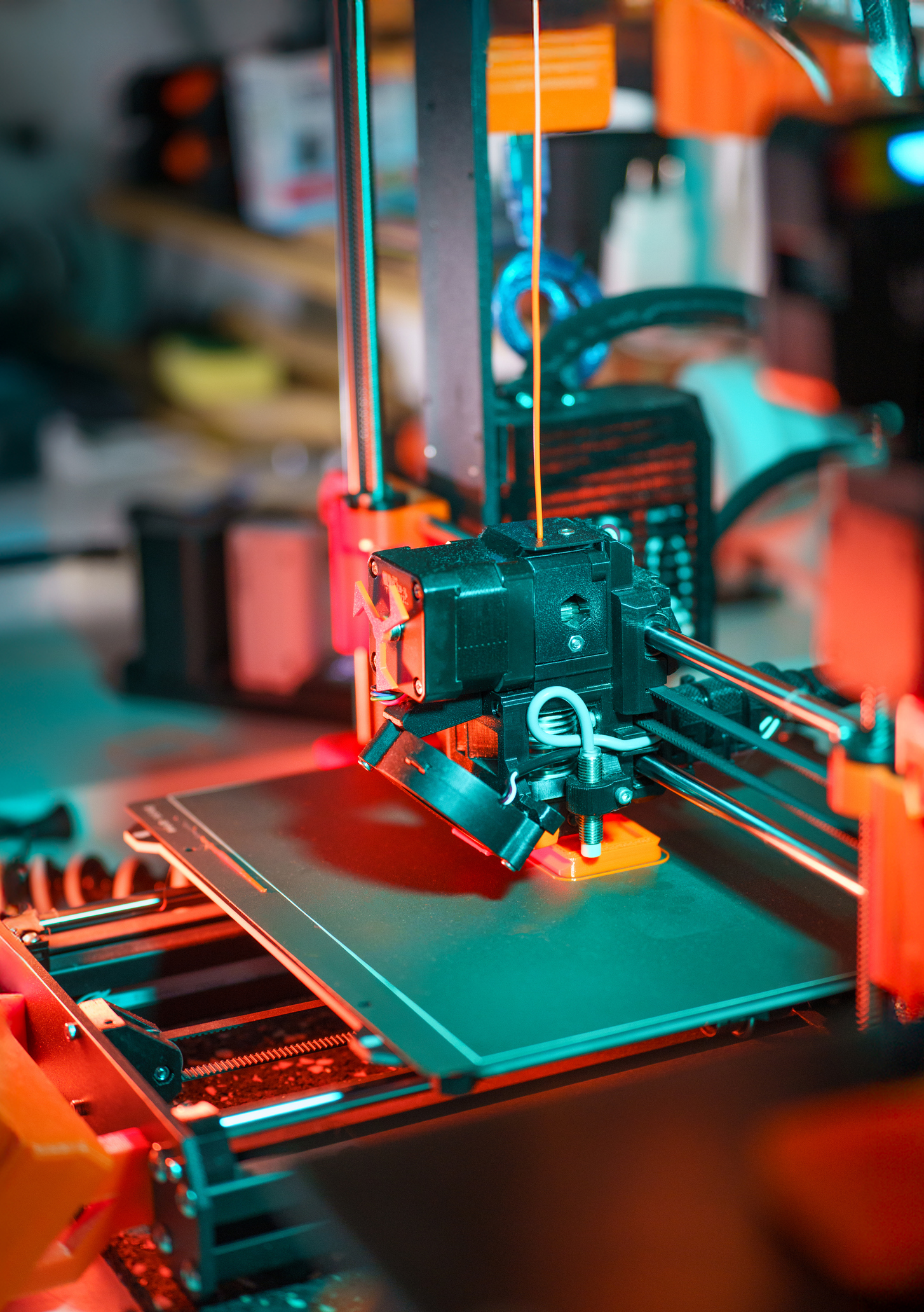 3D printer creating an orange object