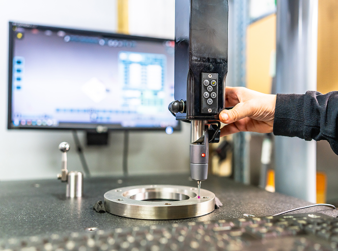 Engineer calibrating industrial machine