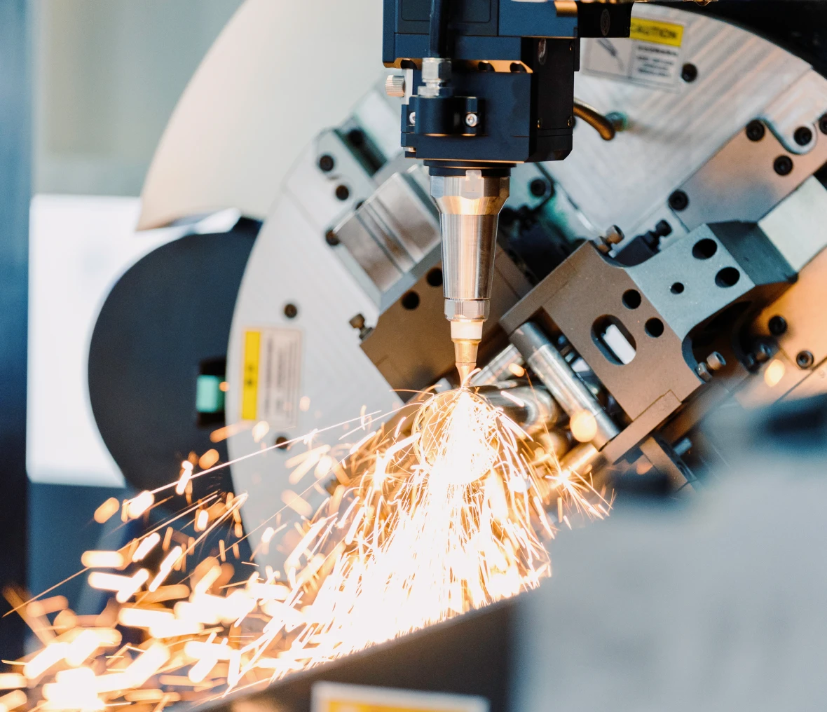 Industrial machine cutting metal with sparks flying